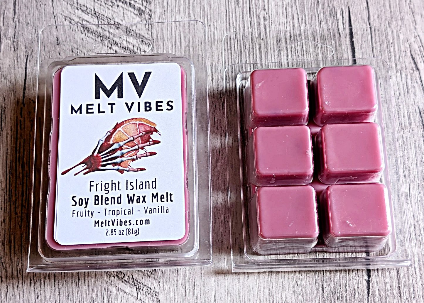 Pink wax melts in a clear plastic packaging with 'Melt Vibes' label on a wooden surface.