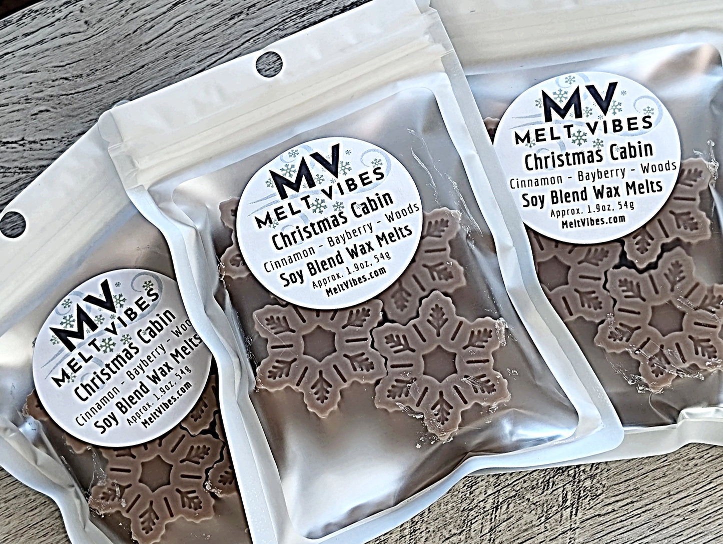 Packaged wax melts with 'Melt Vibes' labels on a wooden surface