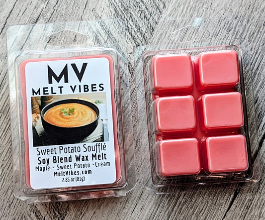 Two packages of MV Melt Vibes soy blend wax melt in the Sweet Potato Soufflé scent, shown on a gray wood background. One package shows the front label, and the other shows the six pink wax melts inside a clear plastic clamshell.