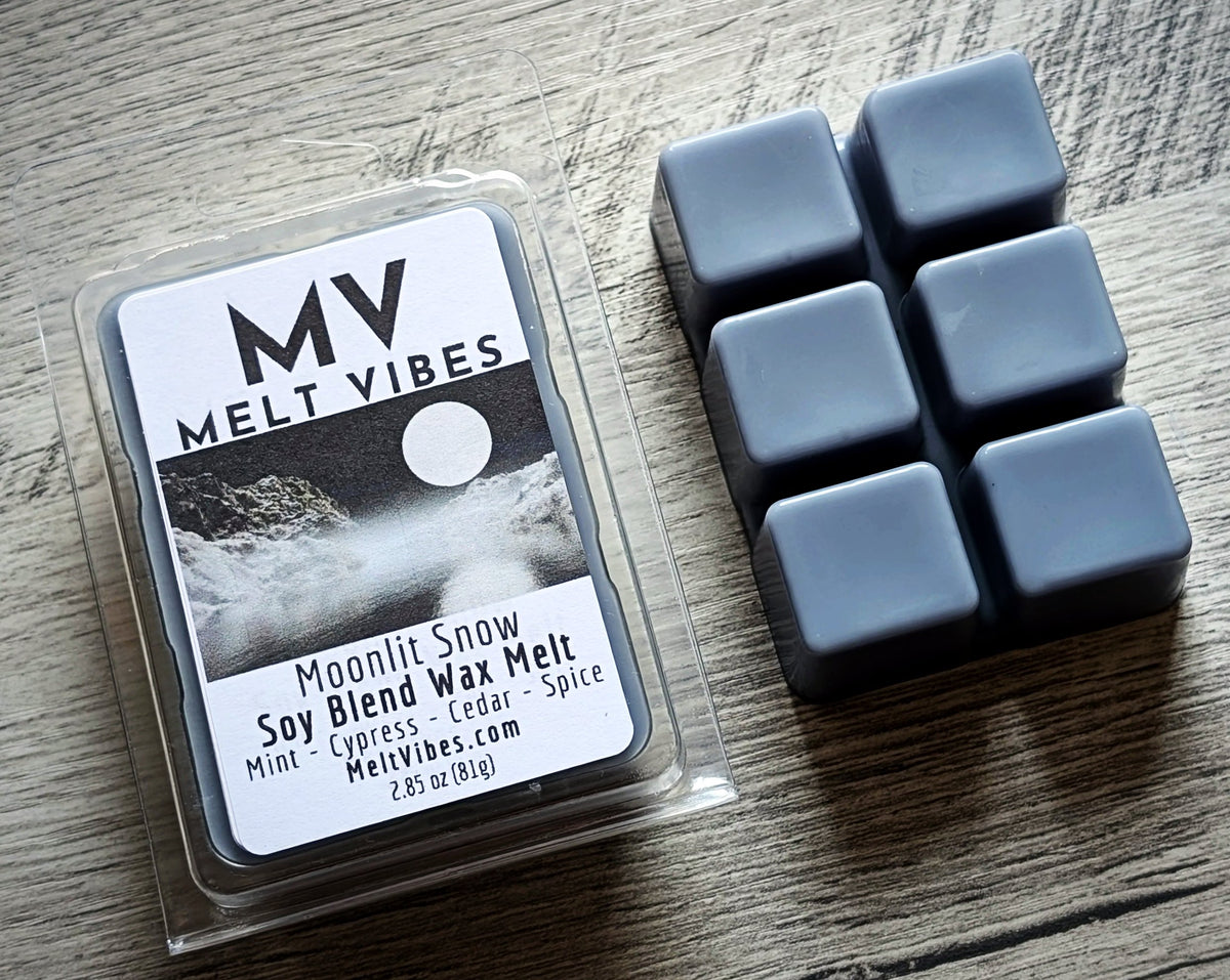 Wax melts in packaging with 'Melt Vibes' branding on a wooden surface