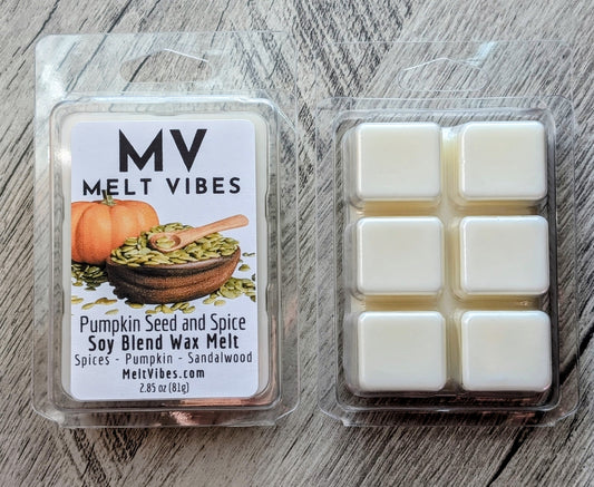 Two wax melts in clear clamshell packaging on a gray wood surface. The left package shows the front label for 'MV Melt Vibes' Pumpkin Seed and Spice soy blend wax melt, and the right package shows six white wax melts arranged in a grid.