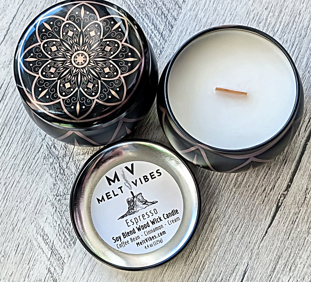 Melt Vibes candle in a decorative tin on a wooden surface