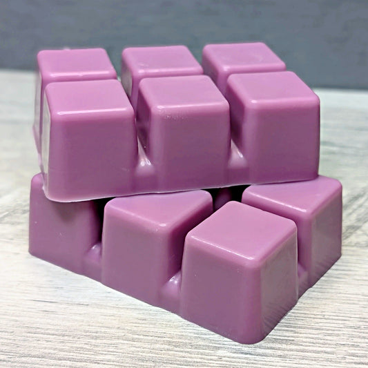 Stack of purple wax cubes on a textured surface