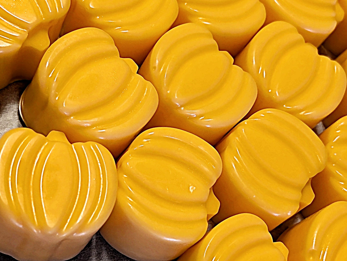 Close-up of yellow-orange mini wax melt pumpkins.