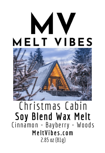 A-frame cabin in snowy woods, warm lights inside, label for Christmas-scented wax melt.