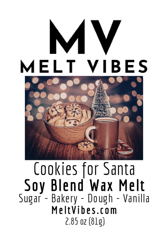 Bowl of cookies, mug, and small tree on a table with warm, glowing lights in the background.