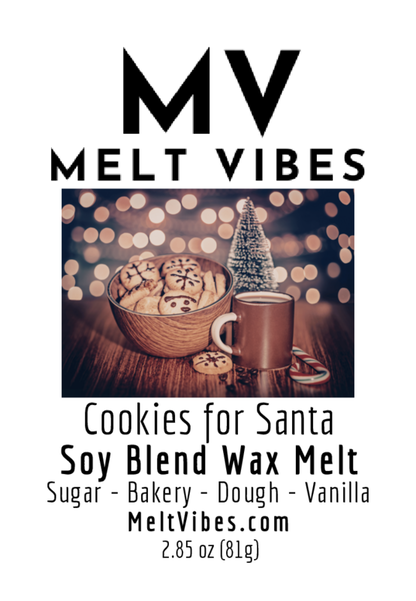 Bowl of cookies, mug, and small tree on a table with warm, glowing lights in the background.