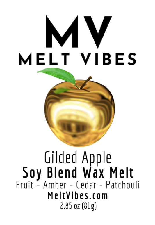 A gold apple with a green leaf on a label reading "MV Melt Vibes Gilded Apple Soy Blend Wax Melt."