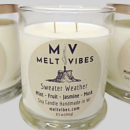 Label of Sweater Weather soy candle showing the brand logo, scent names, and size of the candle.
