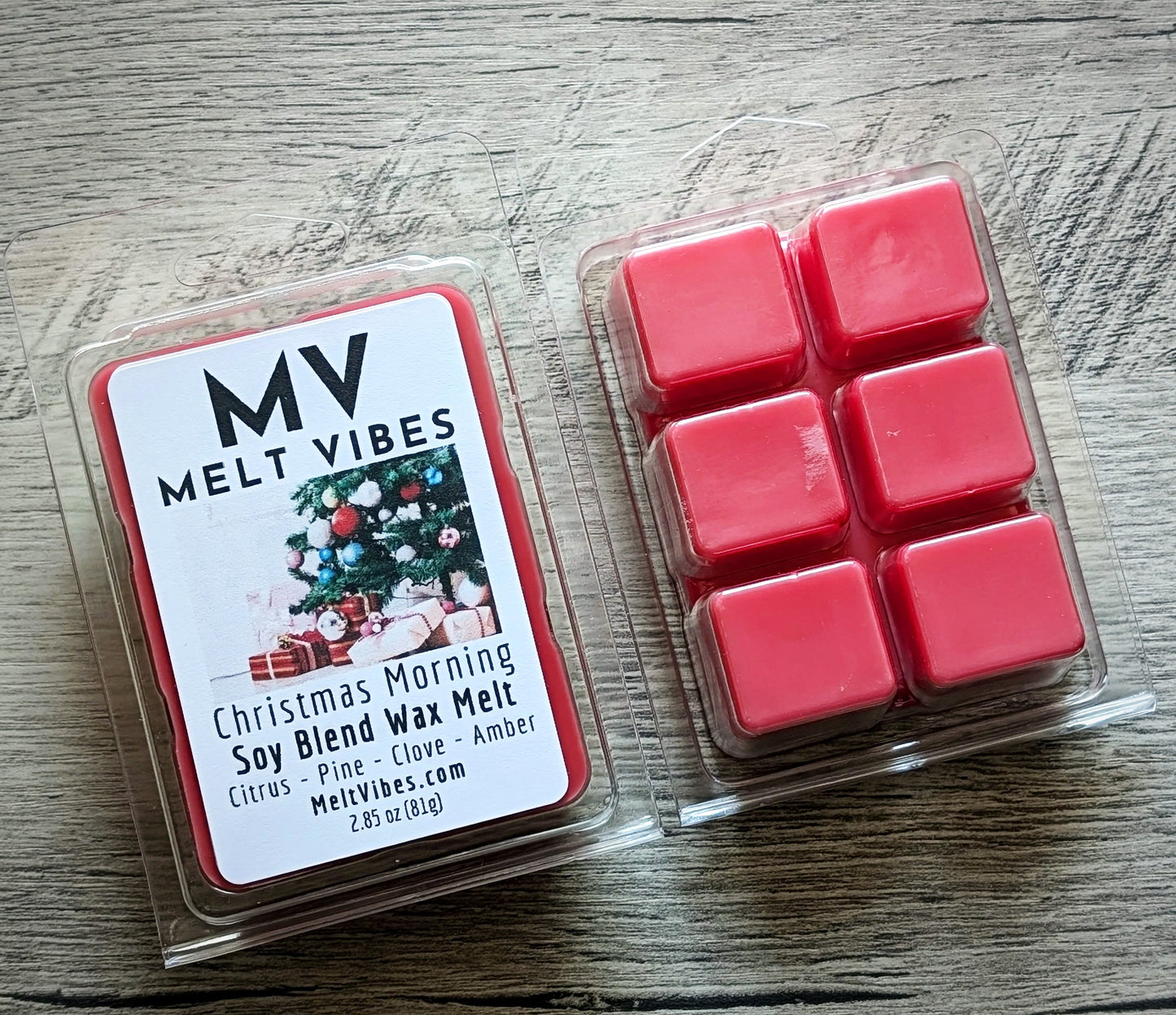 Red wax melts in a clear plastic packaging with Melt Vibes branding on a wooden surface.
