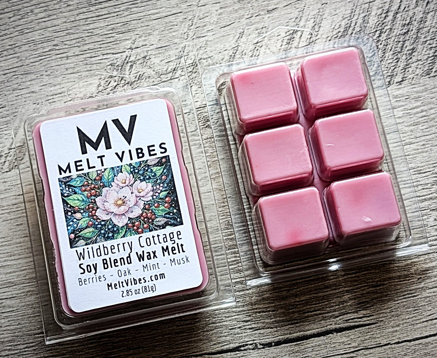Pink wax melts in a clear container with a 'Melt Vibes' label on a wooden surface.