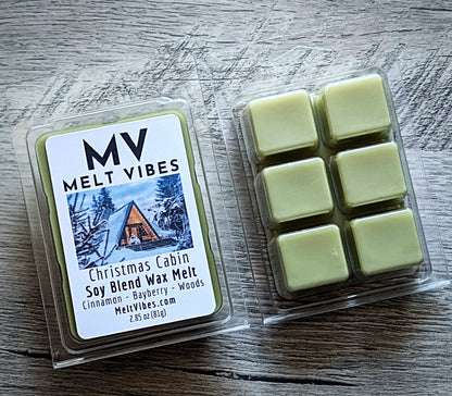 Melt Vibes Christmas Cabin soy blend wax melts in packaging on a wooden surface