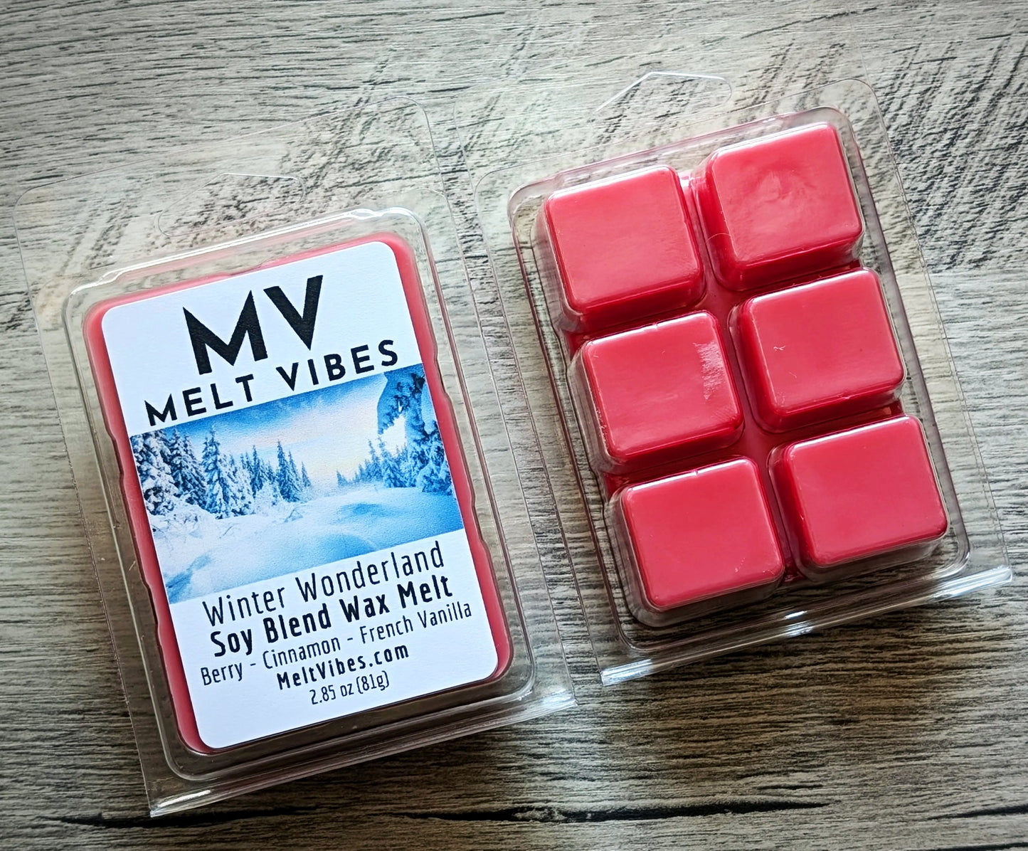 Red wax melts in a clear plastic packaging with 'Melt Vibes' label on a wooden surface
