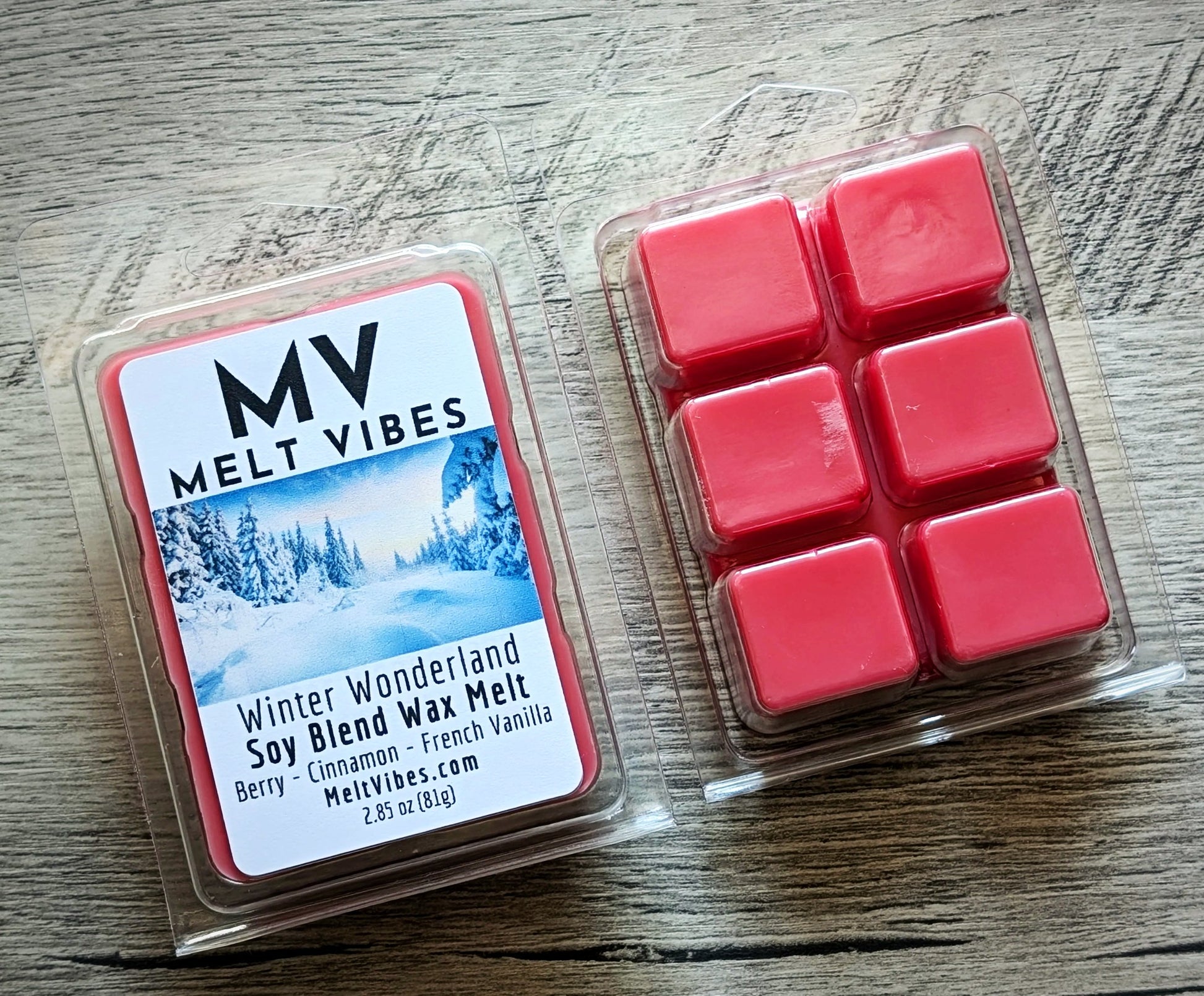 Red wax melts in a clear plastic packaging with 'Melt Vibes' label on a wooden surface