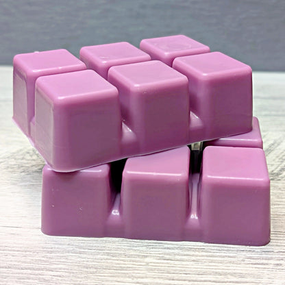 Stack of pink wax cubes on a textured surface