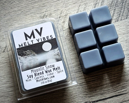Wax melts in packaging with 'Melt Vibes' branding on a wooden surface