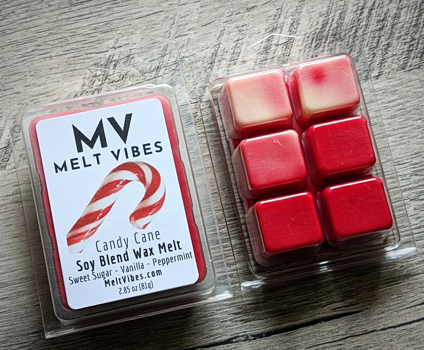 Red wax melt cubes beside clear packaging labeled "MV Melt Vibes, Candy Cane Soy Blend Wax Melt."