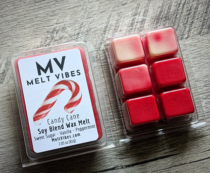 Red wax melt cubes beside clear packaging labeled "MV Melt Vibes, Candy Cane Soy Blend Wax Melt."
