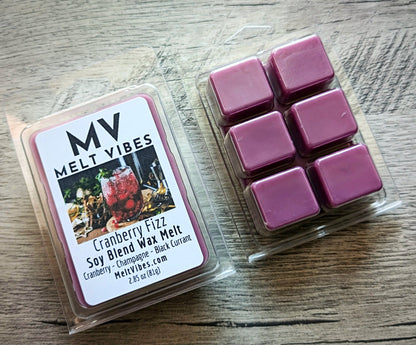 Fuchsia colored wax melts in a clear packaging with 'Melt Vibes' label on a wooden surface